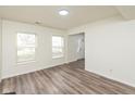 Spacious living room with updated flooring and natural light from two large windows at 6853 Bretton Wood Dr, Indianapolis, IN 46268