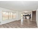 Open concept living space with new flooring, a staircase, and views into the modern kitchen at 6853 Bretton Wood Dr, Indianapolis, IN 46268