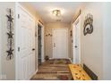Welcoming entryway with wood flooring, bench, and decorative wall art at 6953 Beargrass Ct, Indianapolis, IN 46241
