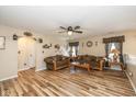 Cozy living room featuring wood flooring, ceiling fan, and comfortable seating at 6953 Beargrass Ct, Indianapolis, IN 46241
