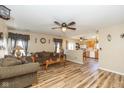 Open concept living room showcasing wood floors and seamlessly connecting to the kitchen at 6953 Beargrass Ct, Indianapolis, IN 46241