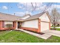 Charming home featuring a manicured lawn and brick and siding exterior accents at 7150 Brant Pointe Cir, Indianapolis, IN 46217