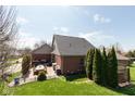 Spacious backyard with a patio, seating area, grill, and well-maintained lawn at 7322 Franklin Parke Ct, Indianapolis, IN 46259