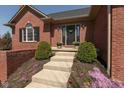 Inviting front entrance with well-maintained landscaping, planters and a welcoming front door at 7322 Franklin Parke Ct, Indianapolis, IN 46259