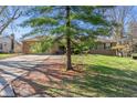 Traditional brick home with attached garage, featuring a beautiful tree in the front yard at 745 W Banta Rd, Indianapolis, IN 46217