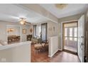 Bright living room entrance with wood-look flooring and view into the dining room; natural light streams in at 758 Stafford Rd, Plainfield, IN 46168