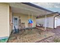 Cozy covered patio with comfortable seating, rocking chairs, and a porch swing, perfect for relaxing at 7764 S State Road 109, Markleville, IN 46056