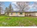 Charming single-story home with light yellow siding, a cozy porch, and inviting curb appeal at 7764 S State Road 109, Markleville, IN 46056