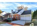 Lovely two-story brick home with an attached two-car garage and mature landscaping at 8040 Lynch Ln, Indianapolis, IN 46250