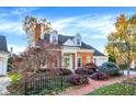 Well-maintained brick home featuring mature trees and manicured garden beds at 8040 Lynch Ln, Indianapolis, IN 46250