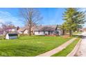 Spacious backyard features a well-maintained lawn, mature trees, and a charming deck for outdoor enjoyment at 923 Jonathan Dr, Plainfield, IN 46168