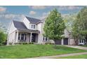 Attractive two-story brick home with a well-kept lawn, covered porch, and attached two-car garage at 10365 Aurora Ct, Fishers, IN 46038