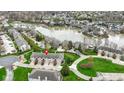 Scenic aerial view of lakeside townhomes, showcasing waterfront living and manicured landscaping at 11339 Fonthill Dr, Indianapolis, IN 46236