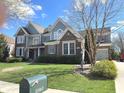 Inviting home with a brick facade, a well-manicured lawn, and a charming mailbox in a serene neighborhood at 11863 Edgefield Dr, Fishers, IN 46037