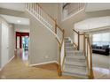Grand foyer with staircase, hardwood floors, and neutral paint at 12479 Autumn Gate Way, Carmel, IN 46033