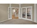 Office features French doors, neutral paint, and carpet flooring at 12479 Autumn Gate Way, Carmel, IN 46033