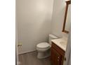 Cozy half bathroom features neutral paint, a vanity sink, and standard toilet at 1254 Kenwood Dr, Greenwood, IN 46143
