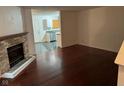 Open living room with fireplace and hardwood floors leading into the kitchen area at 1254 Kenwood Dr, Greenwood, IN 46143