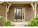 Inviting front door framed by brick and sidelights, offering a glimpse of the home's character at 13778 Driftwood Dr, Carmel, IN 46033