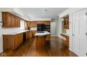 Traditional kitchen with wood cabinets, an island cooktop, and modern black appliances at 13778 Driftwood Dr, Carmel, IN 46033
