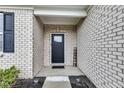 Inviting front porch with brick facade and 'Welcome' sign at 1407 Allen Ct, Shelbyville, IN 46176