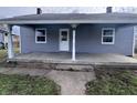 Charming home's front porch featuring classic white columns, windows, and the house number 1445 at 1445 S Belmont Ave, Indianapolis, IN 46221