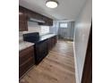 This kitchen features wood-look flooring, black appliances, and plentiful countertop space at 1445 S Belmont Ave, Indianapolis, IN 46221
