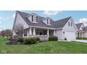 A charming home showcasing a cozy front porch, well-maintained landscaping, and beautiful curb appeal at 15129 Smithfield Dr, Westfield, IN 46074