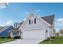 Exterior view of a home with a two-car garage, front porch, and well-kept lawn at 15129 Smithfield Dr, Westfield, IN 46074