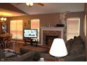 Inviting living room with a brick fireplace, neutral colors, and great natural light from large windows at 1631 Wilford Ln, Indianapolis, IN 46229
