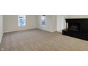 Bright living room with a fireplace and carpeted floors at 1632 Queensbridge Sq # 7, Indianapolis, IN 46219