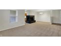 Comfortable living room featuring a black brick fireplace, carpeted floors and neutral paint at 1632 Queensbridge Sq # 7, Indianapolis, IN 46219
