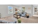 Inviting living room with large windows, a sofa, and stylish decor, offering a bright and airy feel at 1632 Queensbridge Sq # 7, Indianapolis, IN 46219
