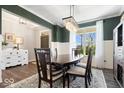 Elegant dining room with wood table, chandelier, and large window offering natural light at 16688 Bowesmont Dr, Fortville, IN 46040