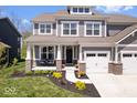 Charming two-story home features a welcoming porch, attached two-car garage, and a well-maintained front yard at 16688 Bowesmont Dr, Fortville, IN 46040