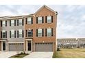 Charming brick-front townhome with a one-car garage and well-maintained landscaping at 17372 Graley Pl, Westfield, IN 46074