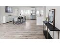 Bright, open dining area with stylish table and chairs, stainless steel refrigerator, and light wood floors at 207 Stephen Ct, Indianapolis, IN 46280