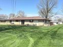 Expansive backyard with a spacious deck, perfect for outdoor entertaining and relaxation at 243 E Benton St, Alexandria, IN 46001