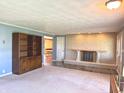 Bright living room with brick fireplace, built-in shelving, and slate tile entryway at 243 E Benton St, Alexandria, IN 46001