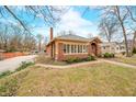 Quaint brick home with well maintained lawn and vintage design, surrounded by mature trees at 251 E South St, Franklin, IN 46131