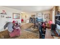 Cozy living room featuring a large rug, comfortable seating, and a functional workspace at 3024 N Huber St, Indianapolis, IN 46226