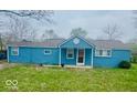 Charming exterior of a light blue home with a welcoming front porch at 3126 Newhart St, Indianapolis, IN 46217