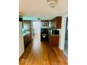 Kitchen featuring wood floors, black appliances, and stainless steel microwave at 3126 Newhart St, Indianapolis, IN 46217