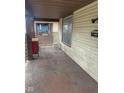 Covered porch area showcasing a weathered floor and white lattice at 330 N Beville Ave, Indianapolis, IN 46201