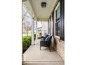 Inviting front porch with comfortable seating, offering a relaxing outdoor space with brick and white trim at 3393 Paisley Pointe, Whitestown, IN 46075