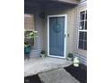 A welcoming front door with a charming sun decoration, potted plants, and a 'Welcome' sign creating a cozy entrance at 3643 Reflections Ln # 5, Indianapolis, IN 46214