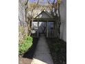 Inviting walkway leading to the entrance of a cozy home, surrounded by lush greenery and privacy at 3643 Reflections Ln # 5, Indianapolis, IN 46214