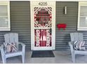 Inviting front porch with seating and a decorative door at 4205 Rookwood Ave, Indianapolis, IN 46208