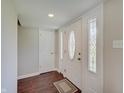 Bright entryway featuring dark hardwood flooring, white trim, and natural light at 4389 S Brooklawn Dr, New Palestine, IN 46163