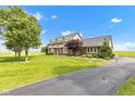 Spacious two-story home with lush green lawn, brick accents and long driveway at 4545 W 200 S, Lebanon, IN 46052